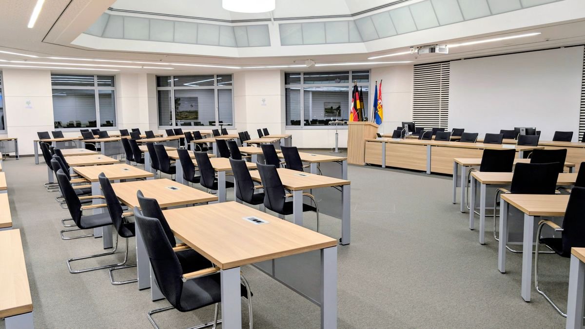Spacious and modern meeting room in with desks and flags