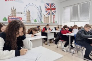 Students focus on an English class study session in a London-themed classroom