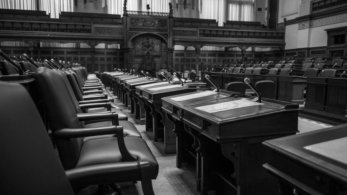 Black and white photo of a traditional legislative assembly chamber