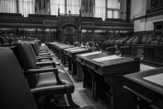 Black and white photo of a traditional legislative assembly chamber