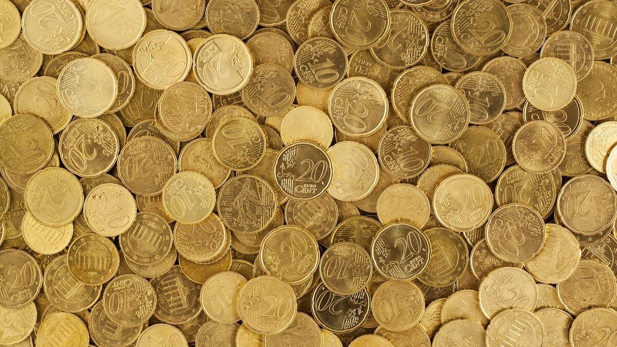A close-up shot of Euro coins scattered in a pile