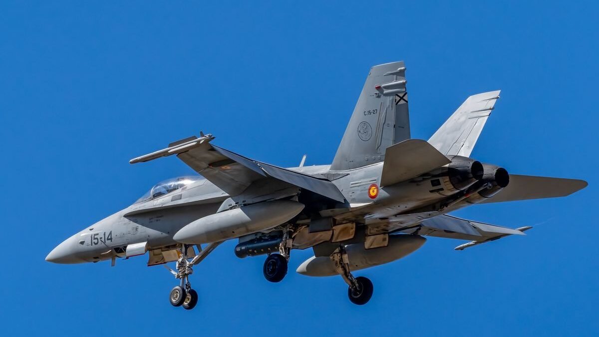 Close-up of a Spanish Air Force F/A-18 Hornet flying against a clear blue sky