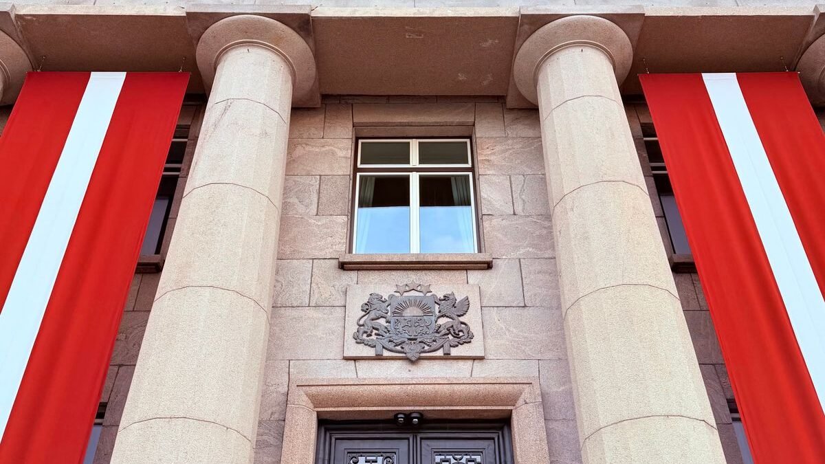 Grand architectural facade with columns and flags