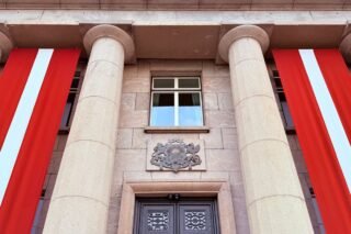 Grand architectural facade with columns and flags