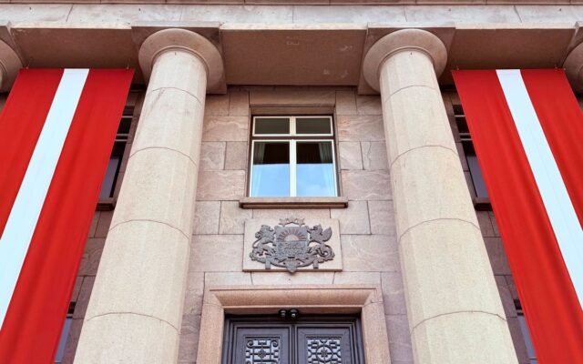 Grand architectural facade with columns and flags