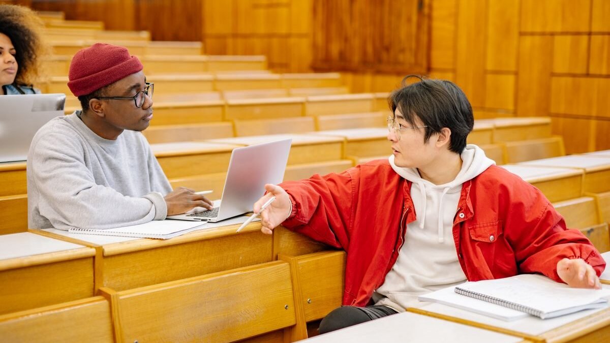 University students discussing during a class in a lecture hall