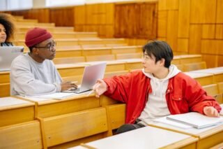 University students discussing during a class in a lecture hall