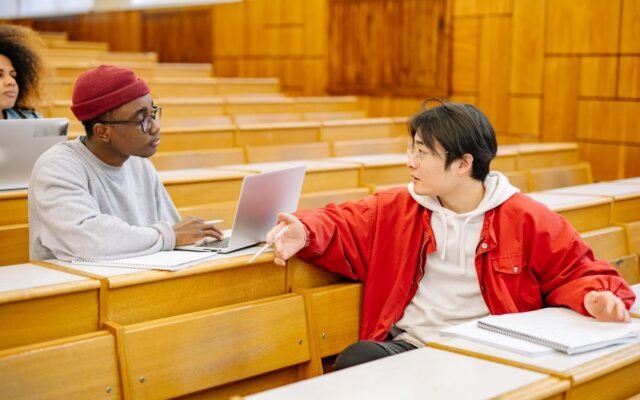 University students discussing during a class in a lecture hall