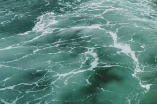 Captivating aerial view of turquoise ocean waves and white surf texture