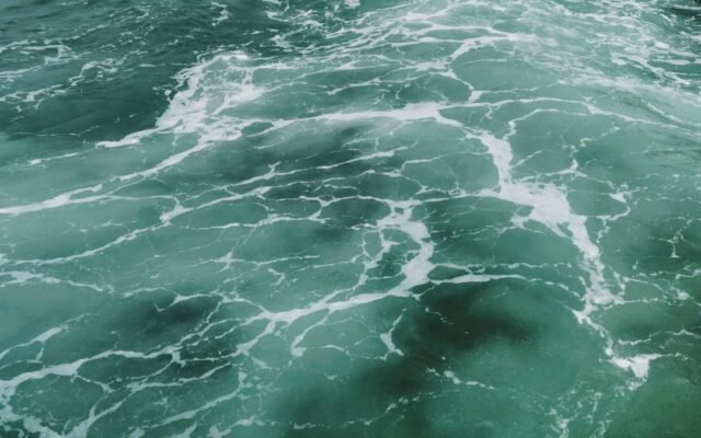 Captivating aerial view of turquoise ocean waves and white surf texture