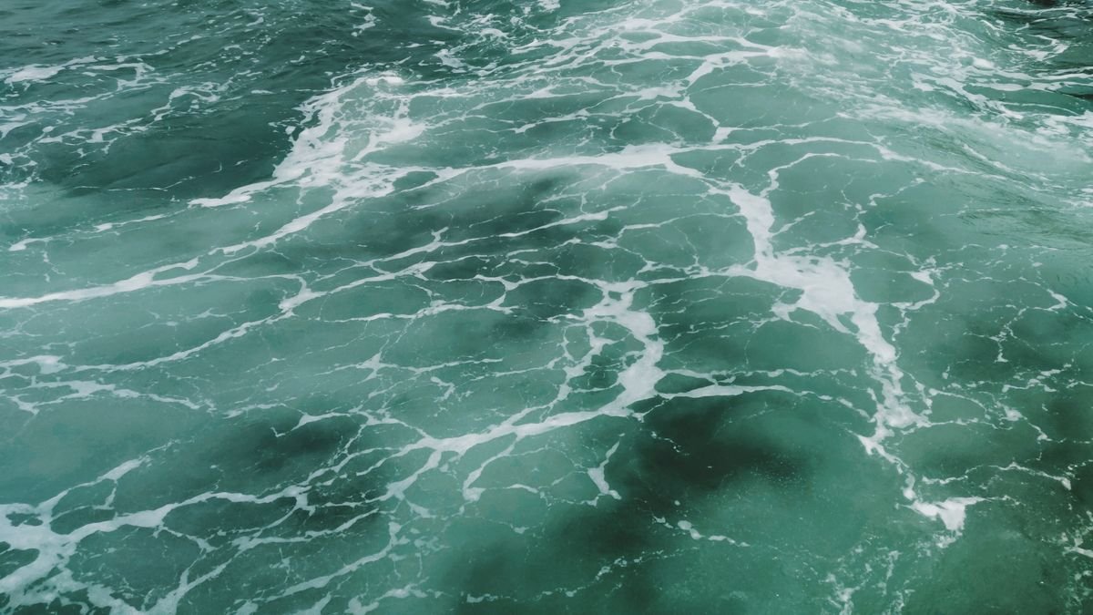 Captivating aerial view of turquoise ocean waves and white surf texture