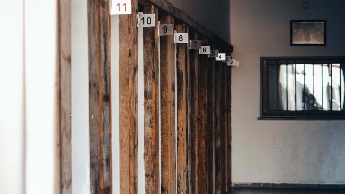 Explore this atmospheric corridor with wooden frames and numbered partitions in low lighting