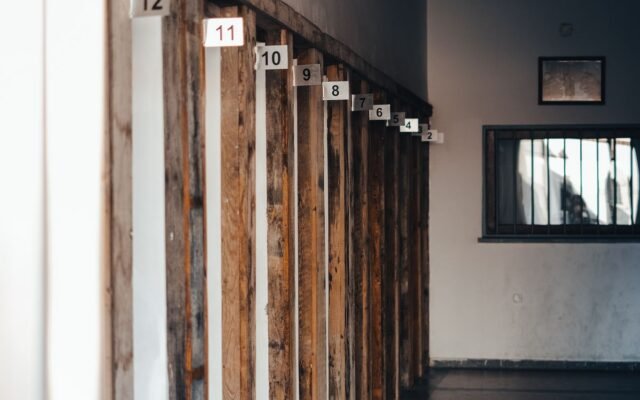 Explore this atmospheric corridor with wooden frames and numbered partitions in low lighting