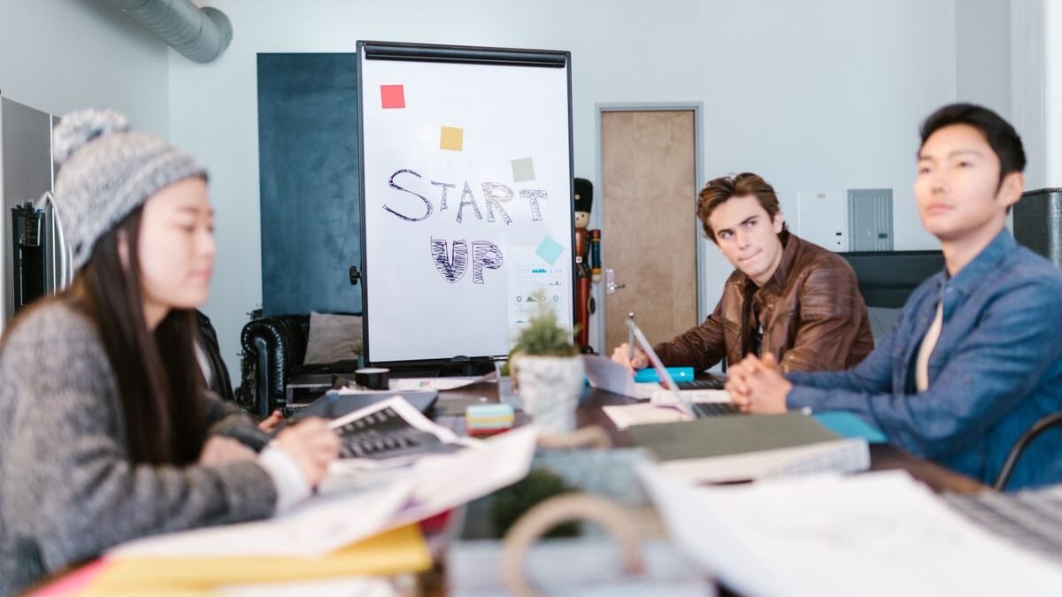 A group of young professionals brainstorming ideas in a startup office setting