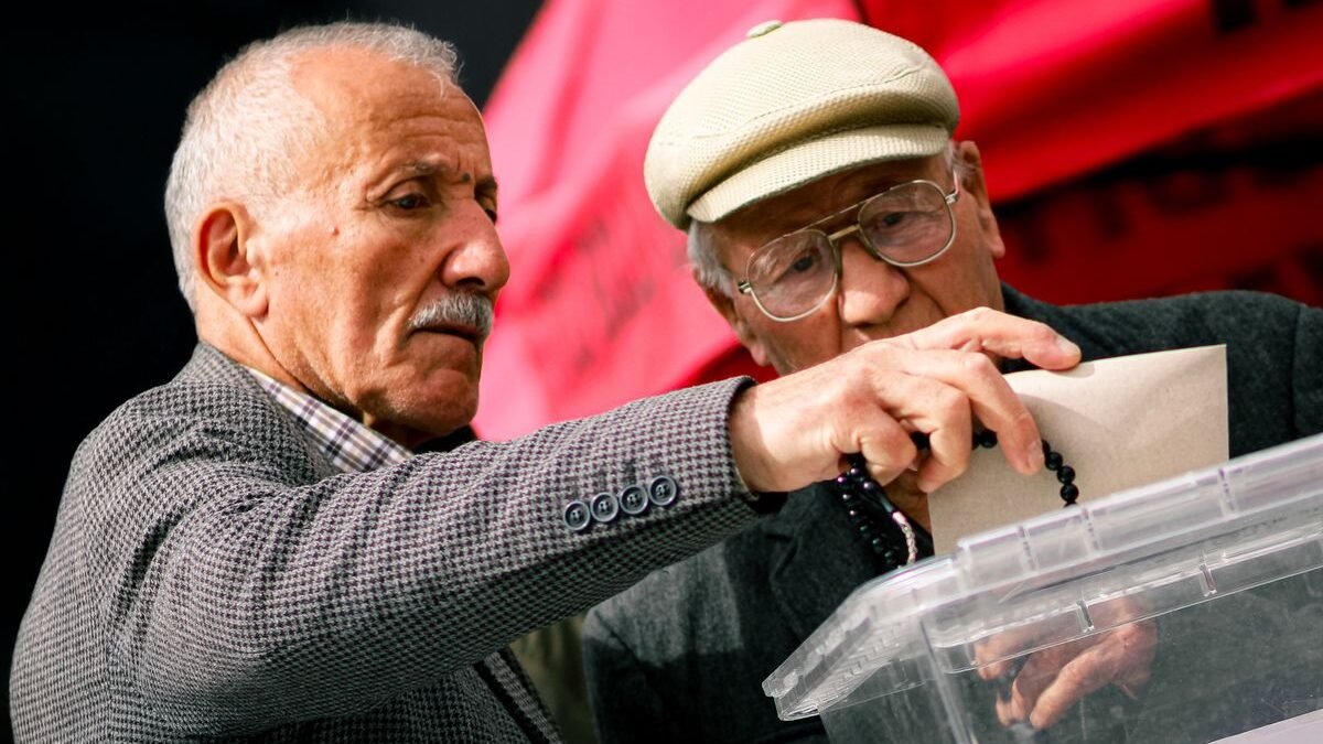 Two senior adults casting their votes at election polls