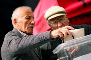 Two senior adults casting their votes at election polls