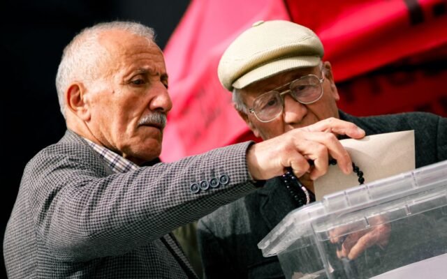 Two senior adults casting their votes at election polls
